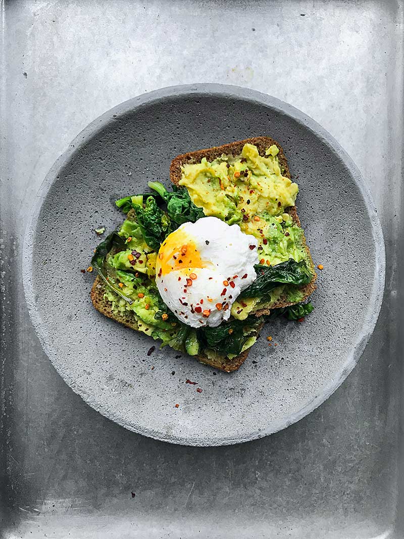 Smashed avocado with poached egg on toast